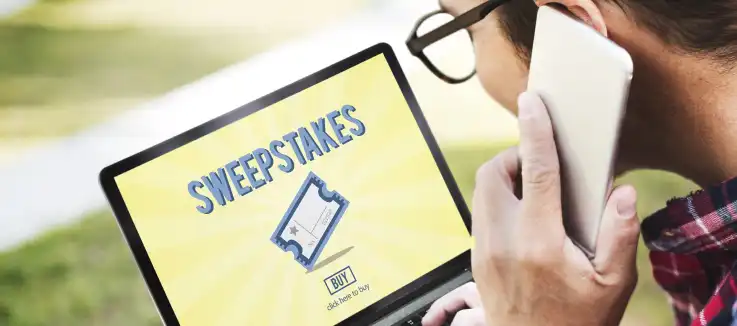 man looking at a screen that displays a "Sweepstakes" notification