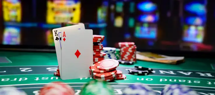 stack of chips next to a hand of blackjack