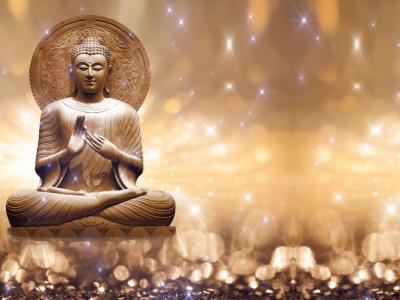 likeness of Buddha on a gold sparkly background